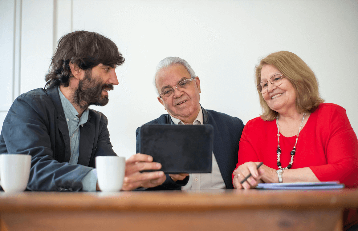 An advisor happily showing solutions to his clients.