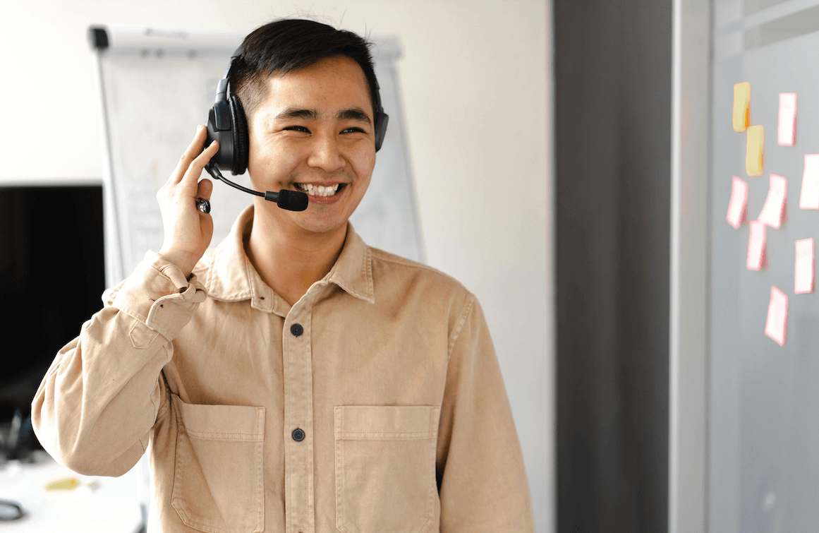 a picture of a smiling agent taking a phone call