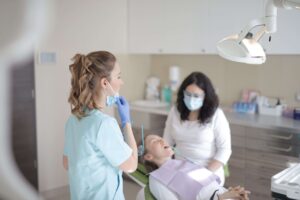 Dental hygienist and patient during a checkup, illustrating supplemental insurance options for dental care